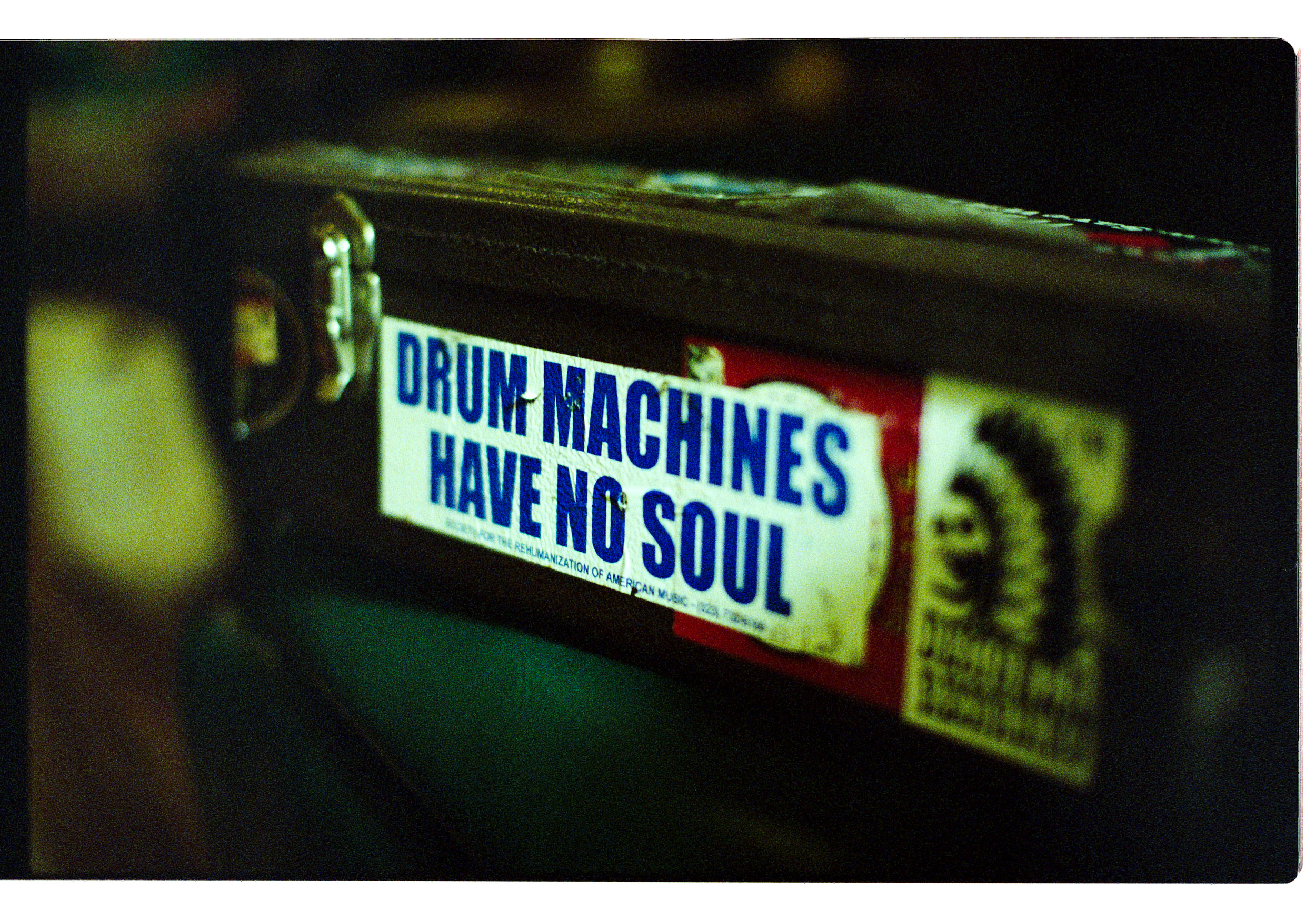 Close up of a sticker that says GUITAR MACHINES HAVE NO SOUL in blue type